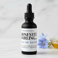 Ohm and Ember Candles Honestly Darling face oil with blue tansy, rosehip, argan, jojoba, and castor oils for a dewy glow.